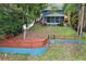 Backyard showcasing a spacious deck, blue retaining wall, and screened-in porch on a lakeside property at 858 Lake Marion Dr, Altamonte Springs, FL 32701