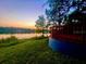 Backyard lawn overlooking the lake at sunset at 858 Lake Marion Dr, Altamonte Springs, FL 32701
