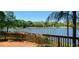Wooden deck overlooking a serene lake surrounded by lush trees and greenery at 858 Lake Marion Dr, Altamonte Springs, FL 32701