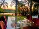 Dining area with table, chairs, and gorgeous lake views at sunset at 858 Lake Marion Dr, Altamonte Springs, FL 32701