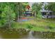 Back exterior of a charming lake house features a spacious deck, screened porch, and lush backyard at 858 Lake Marion Dr, Altamonte Springs, FL 32701
