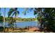 Expansive lake view from a wood deck, surrounded by mature trees and lush landscaping at 858 Lake Marion Dr, Altamonte Springs, FL 32701