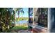 Relaxing screened porch with a view of the lake, palm trees, and fence at 858 Lake Marion Dr, Altamonte Springs, FL 32701