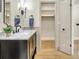 Renovated bathroom featuring a vanity with marble countertop and an open linen closet at 1011 Terry Dr, Altamonte Springs, FL 32714