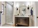Chic bathroom with marble countertop vanity, decorative sconces, and tiled walk-in shower at 1011 Terry Dr, Altamonte Springs, FL 32714