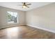 Bright bedroom featuring a ceiling fan, wood-look flooring, and a window with natural light at 1011 Terry Dr, Altamonte Springs, FL 32714