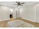 Simple bedroom with wood floors, neutral walls, a large window, and modern ceiling fan at 1011 Terry Dr, Altamonte Springs, FL 32714