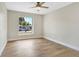 Bright bedroom featuring a ceiling fan, wood-look flooring, and a window with natural light at 1011 Terry Dr, Altamonte Springs, FL 32714