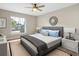Furnished bedroom featuring a gray bed frame, carpet, two lamps, and natural light at 1011 Terry Dr, Altamonte Springs, FL 32714