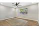 Bright bedroom with hardwood floors, neutral walls, a large window, and modern ceiling fan at 1011 Terry Dr, Altamonte Springs, FL 32714