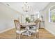 Charming dining area with decorative chandelier and hardwood floors seamlessly connecting to the kitchen at 1011 Terry Dr, Altamonte Springs, FL 32714