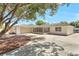 A one-story house with a wide driveway, a garage, an enclosed porch, and a large tree in the yard at 1011 Terry Dr, Altamonte Springs, FL 32714
