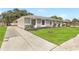 A charming home with a well-kept lawn, inviting driveway, and beautiful stone facade in a lovely neighborhood at 1011 Terry Dr, Altamonte Springs, FL 32714