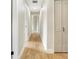 Hallway featuring wood flooring, neutral walls, and white doors at 1011 Terry Dr, Altamonte Springs, FL 32714