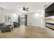 Well-lit living room features stylish seating, a modern fireplace, and wood flooring at 1011 Terry Dr, Altamonte Springs, FL 32714