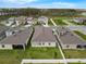 A high aerial view of homes showing green lawns and proximity to a wooded area at 10151 Salt Point Dr, Winter Garden, FL 34787