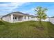 A well-maintained backyard with lush green grass, a small tree, and a white picket fence at 10151 Salt Point Dr, Winter Garden, FL 34787