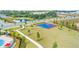 Aerial view showing the outdoor basketball court and lush green spaces perfect for recreation at 10151 Salt Point Dr, Winter Garden, FL 34787