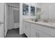 Bathroom with double vanity, quartz countertop, and tiled shower with tub at 10151 Salt Point Dr, Winter Garden, FL 34787