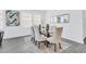 A bright dining area features a glass table with seating for six and views of the exterior at 10151 Salt Point Dr, Winter Garden, FL 34787