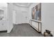 Entry hallway with gray wood floors, stylish decor, and a view into the adjacent bathroom at 10151 Salt Point Dr, Winter Garden, FL 34787