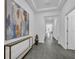 Bright entryway with gray wood floors, modern decor, and views down the hallway at 10151 Salt Point Dr, Winter Garden, FL 34787