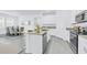 Open kitchen features a central island with bar seating and stainless steel appliances at 10151 Salt Point Dr, Winter Garden, FL 34787