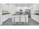 Bright kitchen features white cabinets, stainless steel appliances, and a central island with seating at 10151 Salt Point Dr, Winter Garden, FL 34787