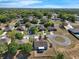 Aerial view of a well-maintained community with mature trees, sidewalks, and manicured lawns at 1028 Marietta Ln, Eustis, FL 32726