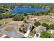 Aerial view of a beautiful home near the lake with lush trees and landscaping in a serene neighborhood at 1028 Marietta Ln, Eustis, FL 32726