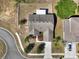 Aerial view of a charming home with a fenced backyard, beautiful landscaping, and a circular driveway at 1028 Marietta Ln, Eustis, FL 32726