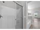 Bright bathroom features a tiled shower with sliding glass door and large soaking tub at 1028 Marietta Ln, Eustis, FL 32726