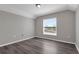 This well-lit bedroom features hard wood floors, natural lighting, and neutral paint at 1028 Marietta Ln, Eustis, FL 32726