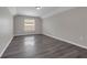 Bright bedroom with large window and hardwood flooring offers a cozy atmosphere at 1028 Marietta Ln, Eustis, FL 32726