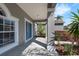 Home's entrance featuring a covered porch, decorative columns, and a blue front door at 1028 Marietta Ln, Eustis, FL 32726