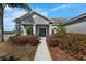 Inviting home exterior with a manicured lawn and a walkway leading to the front door at 1028 Marietta Ln, Eustis, FL 32726