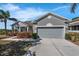 Traditional single-Gathering home featuring a two-car garage and well-maintained landscaping at 1028 Marietta Ln, Eustis, FL 32726