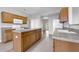Kitchen featuring an island with gray countertops, stainless steel appliances, and wooden cabinetry at 1028 Marietta Ln, Eustis, FL 32726