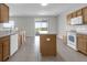 Well-lit kitchen with island and sliding glass doors to the outdoor patio at 1028 Marietta Ln, Eustis, FL 32726