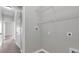 Bright laundry room with tiled floor, neutral walls, and wire shelving for optimal storage and organization at 1028 Marietta Ln, Eustis, FL 32726