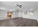 Bright living room featuring wood-look flooring and views of the kitchen at 1028 Marietta Ln, Eustis, FL 32726