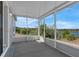 Screened-in patio with serene lake view, perfect for outdoor relaxation and enjoying nature at 1028 Marietta Ln, Eustis, FL 32726