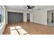 Spacious bedroom with wood floors, a ceiling fan, and an ensuite bathroom at 1037 Sailing Bay Dr, Clermont, FL 34711
