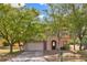 Charming two-story home with a well-maintained lawn and mature trees providing shade and curb appeal at 1037 Sailing Bay Dr, Clermont, FL 34711