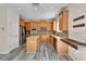Bright kitchen features wooden cabinets, stainless appliances, and a cozy breakfast bar at 1037 Sailing Bay Dr, Clermont, FL 34711
