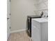 Laundry room with washer, dryer, tile floors, and shelving for storage at 1037 Sailing Bay Dr, Clermont, FL 34711