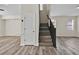 Open living area with wood-look floors, closet, and staircase at 1037 Sailing Bay Dr, Clermont, FL 34711