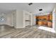 Open floor plan showcasing the living room and kitchen with updated flooring and natural light at 1037 Sailing Bay Dr, Clermont, FL 34711