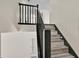 View of staircase featuring wood-look steps and black painted railing at 1037 Sailing Bay Dr, Clermont, FL 34711