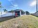 Backyard featuring fenced-in yard, grassy lawn, and covered patio ideal for outdoor entertaining at 104 Bentley Oaks Blvd, Auburndale, FL 33823